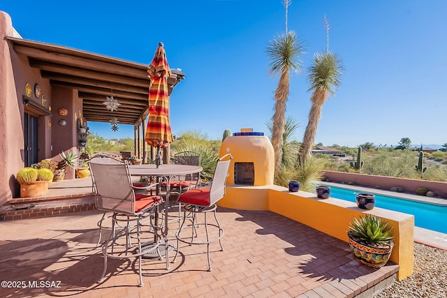 view of patio featuring exterior fireplace