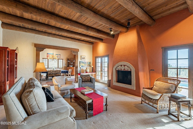 living room with french doors, wood ceiling, light colored carpet, beamed ceiling, and a chandelier