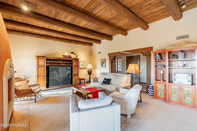 carpeted living room with beam ceiling and wooden ceiling