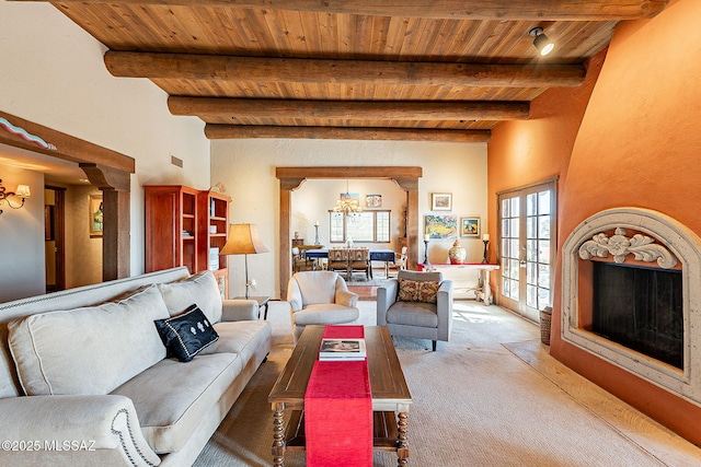 carpeted living room featuring beamed ceiling, plenty of natural light, and wood ceiling