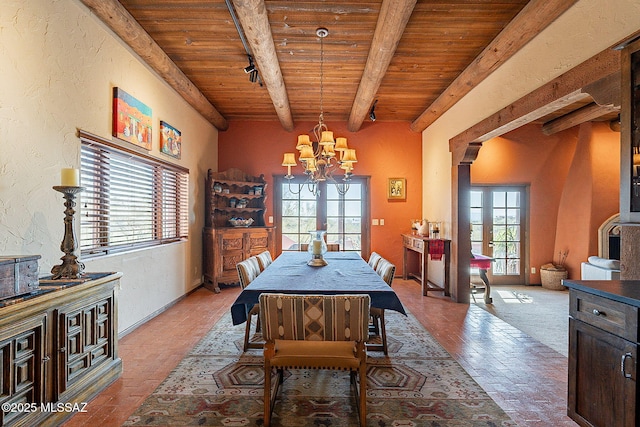 dining area featuring beamed ceiling, wooden ceiling, a wealth of natural light, and french doors