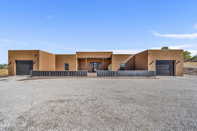 pueblo-style house with a garage