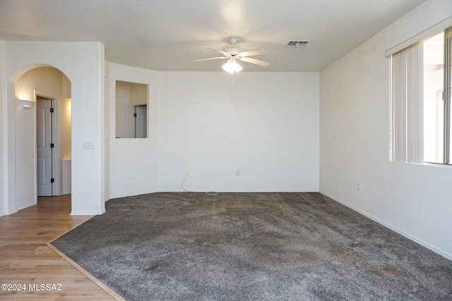 unfurnished room with hardwood / wood-style floors and ceiling fan