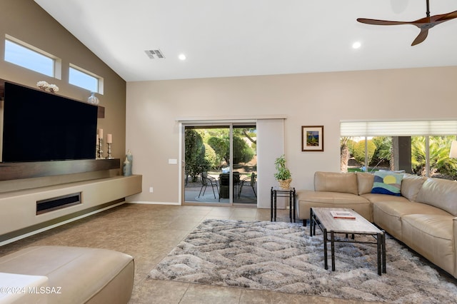 tiled living room featuring ceiling fan and vaulted ceiling