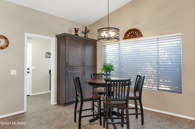 dining room featuring light tile patterned floors, lofted ceiling, and a notable chandelier