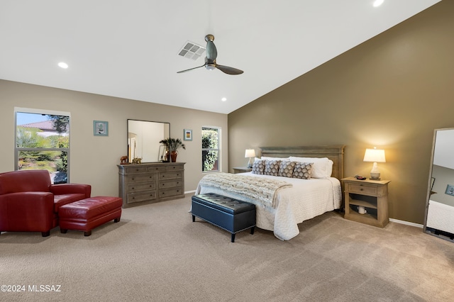 carpeted bedroom with ceiling fan and high vaulted ceiling