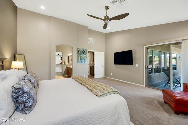 carpeted bedroom featuring ceiling fan, access to exterior, ensuite bathroom, and vaulted ceiling