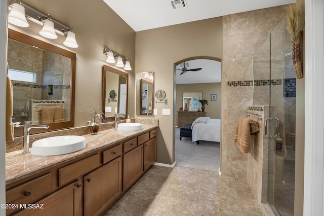 bathroom featuring walk in shower, vanity, and ceiling fan