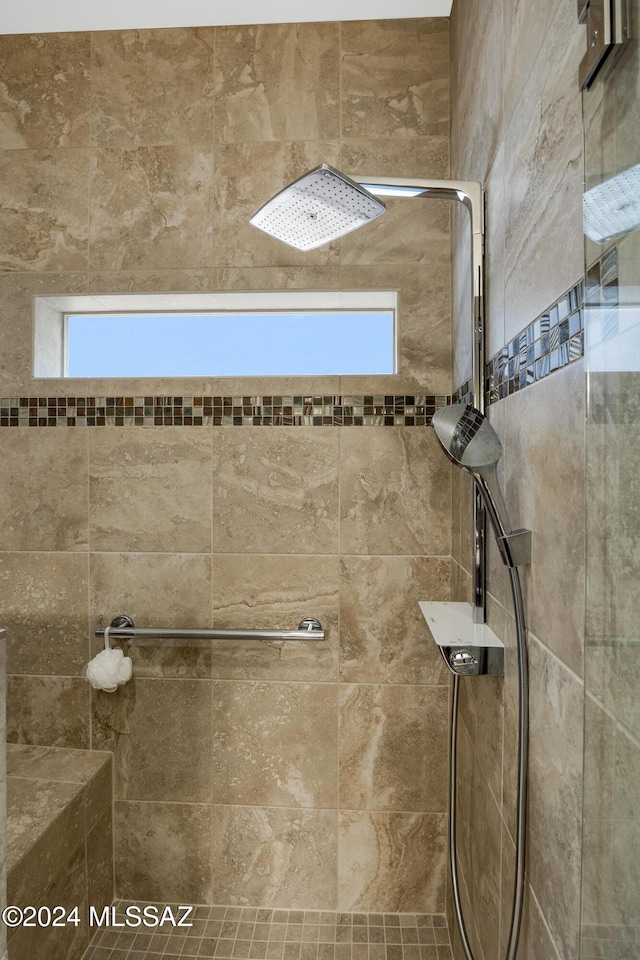 bathroom with a tile shower