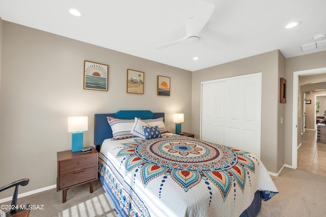 bedroom featuring ceiling fan, a closet, and light carpet