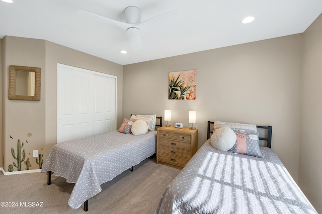 bedroom featuring ceiling fan, light colored carpet, and a closet