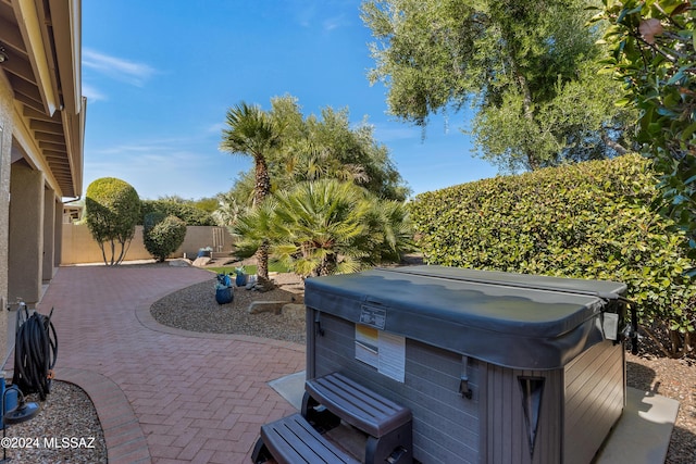 view of patio / terrace with a hot tub