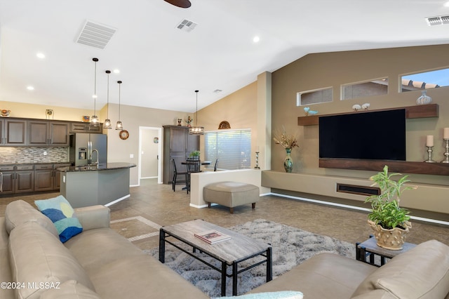 living room featuring a chandelier and lofted ceiling