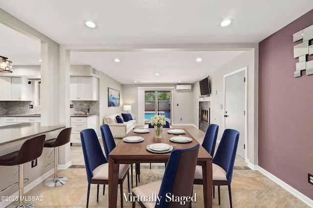 dining area featuring a wall unit AC