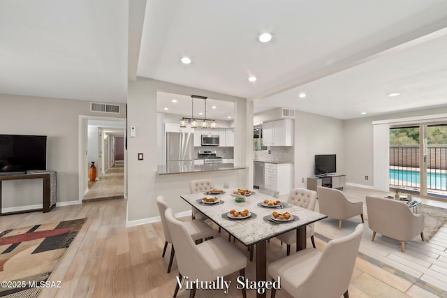 dining area with light wood-type flooring