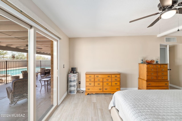 bedroom featuring hardwood / wood-style flooring, ceiling fan, and access to outside