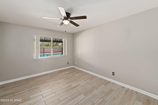 spare room featuring light wood-type flooring and ceiling fan