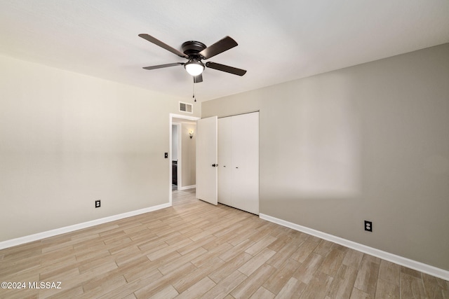 spare room featuring light hardwood / wood-style flooring and ceiling fan