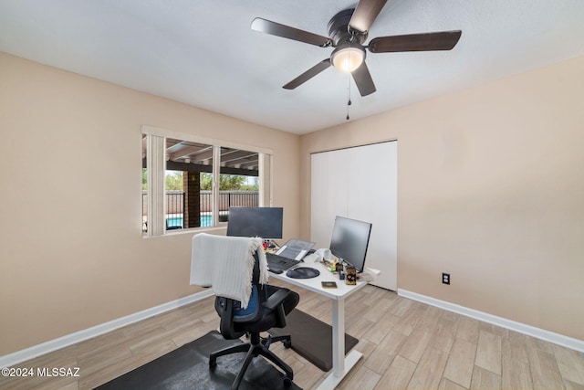 office space with light hardwood / wood-style floors and ceiling fan