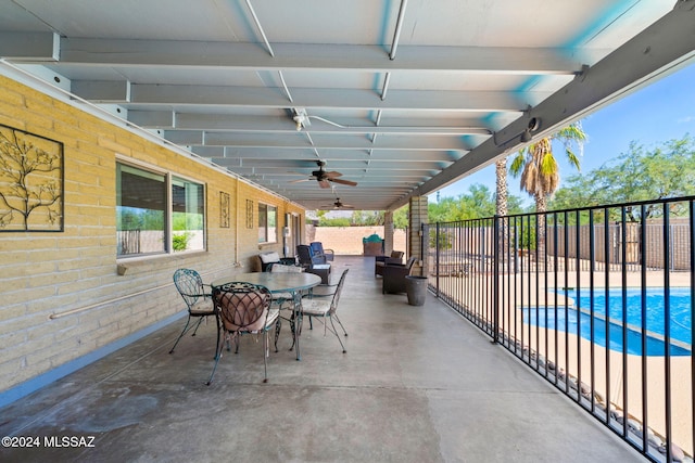 view of patio / terrace with ceiling fan and a fenced in pool