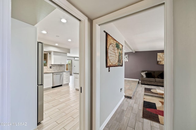 hallway with light hardwood / wood-style floors