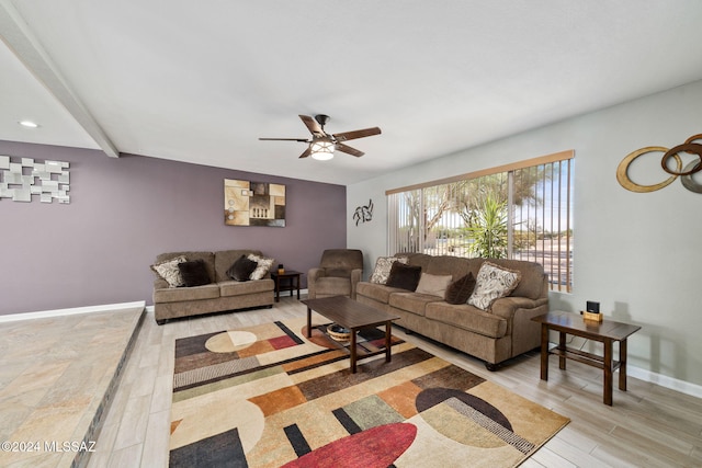 living room featuring ceiling fan, beamed ceiling, and light wood-type flooring