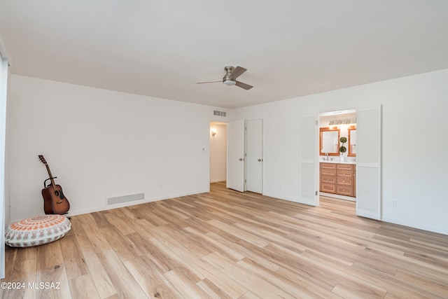 unfurnished bedroom featuring light hardwood / wood-style flooring, ceiling fan, and ensuite bathroom