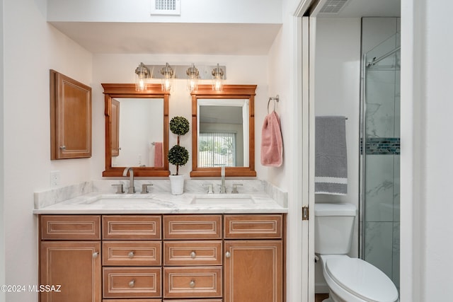 bathroom with an enclosed shower, vanity, and toilet