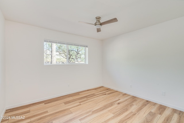 empty room with ceiling fan and light hardwood / wood-style floors