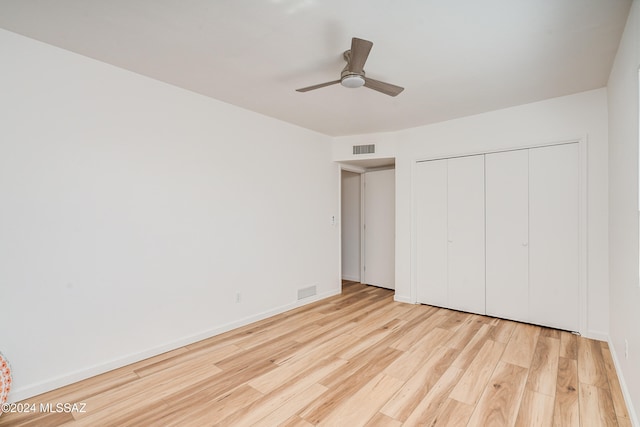 unfurnished bedroom featuring a closet, ceiling fan, and light hardwood / wood-style flooring