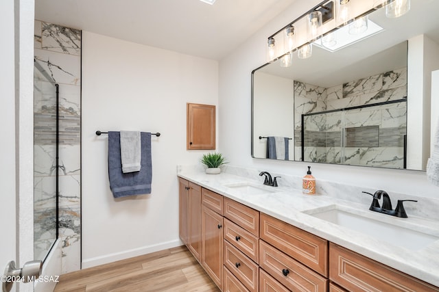 bathroom featuring bath / shower combo with glass door, vanity, and hardwood / wood-style flooring