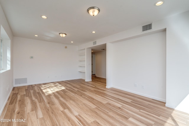 empty room with light hardwood / wood-style flooring