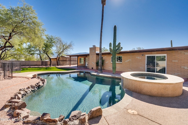 view of pool featuring an in ground hot tub