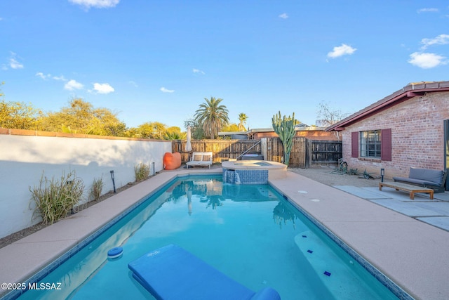 view of swimming pool featuring a patio area, a fenced backyard, and a pool with connected hot tub