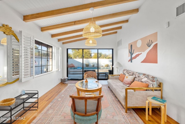 living room with wood finished floors, visible vents, and a wealth of natural light