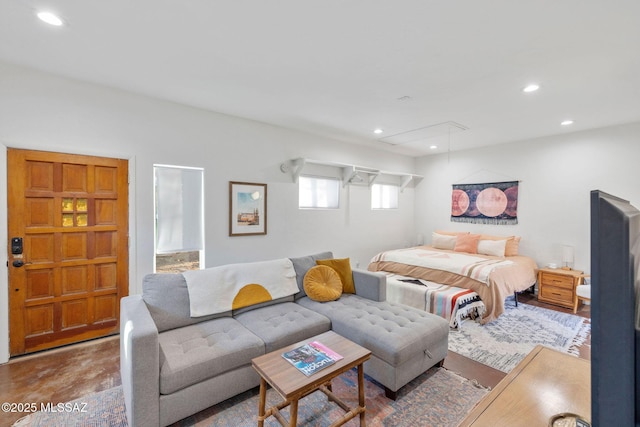 bedroom with recessed lighting, concrete flooring, and attic access