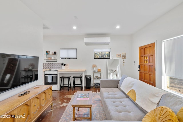 living area with a wall mounted air conditioner, visible vents, concrete flooring, and recessed lighting