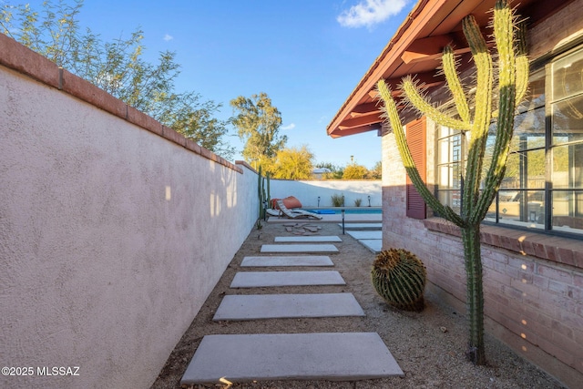 view of yard with a fenced in pool, a patio, and a fenced backyard