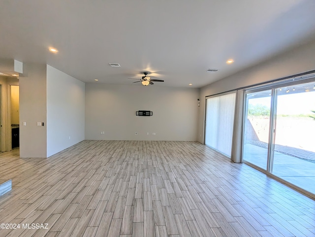 spare room with light hardwood / wood-style floors and ceiling fan