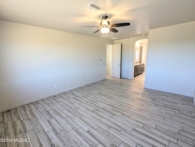 empty room with ceiling fan and light wood-type flooring