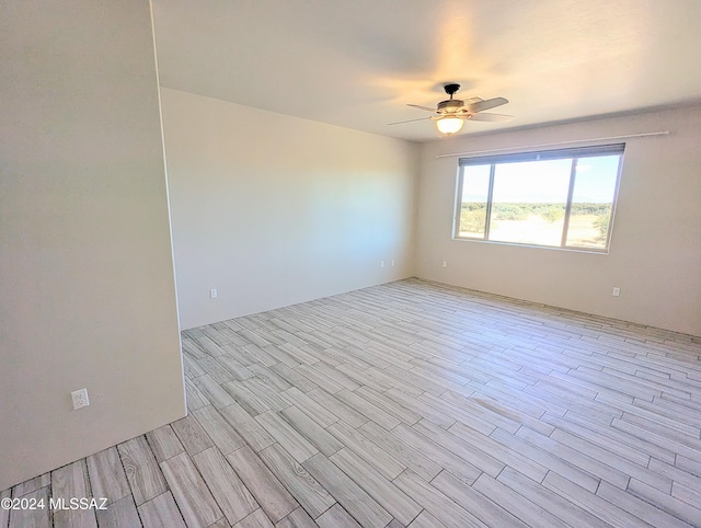 spare room with ceiling fan and light hardwood / wood-style flooring