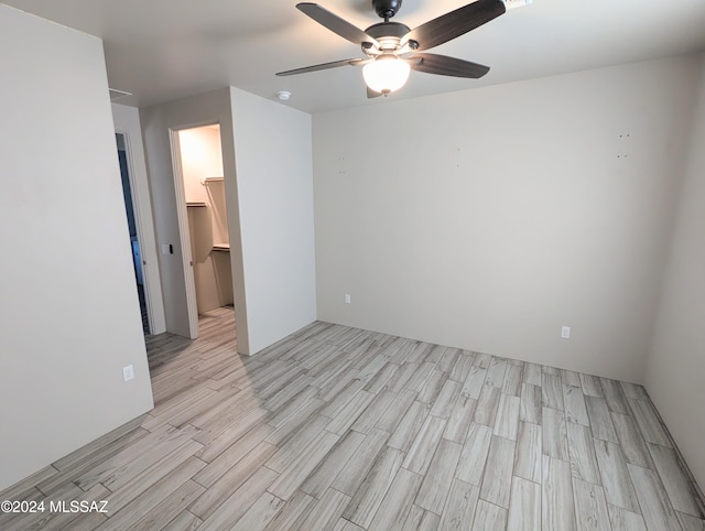 unfurnished room featuring ceiling fan and light wood-type flooring