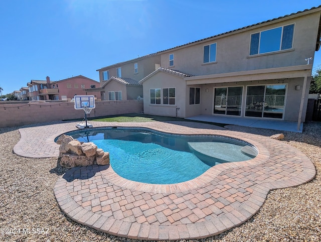 view of pool with a patio and a hot tub