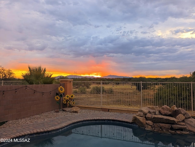 view of pool at dusk