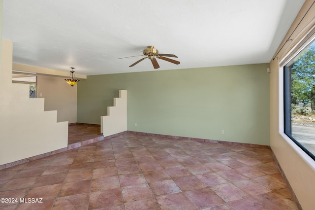 empty room with a wealth of natural light and ceiling fan