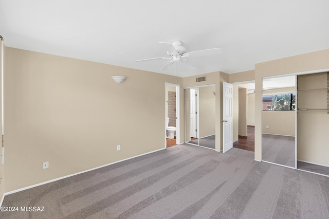 unfurnished bedroom featuring ceiling fan, carpet flooring, ensuite bath, and a closet