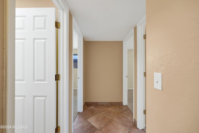 hall featuring light tile patterned floors