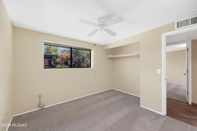 unfurnished bedroom featuring light colored carpet, ceiling fan, and a closet