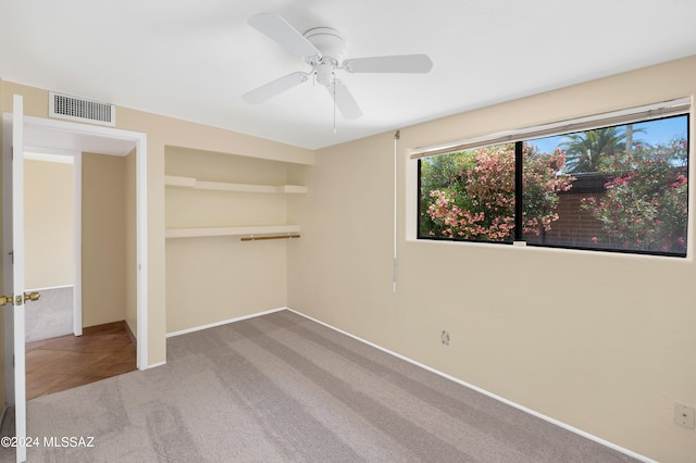 unfurnished bedroom featuring ceiling fan, carpet floors, and a closet