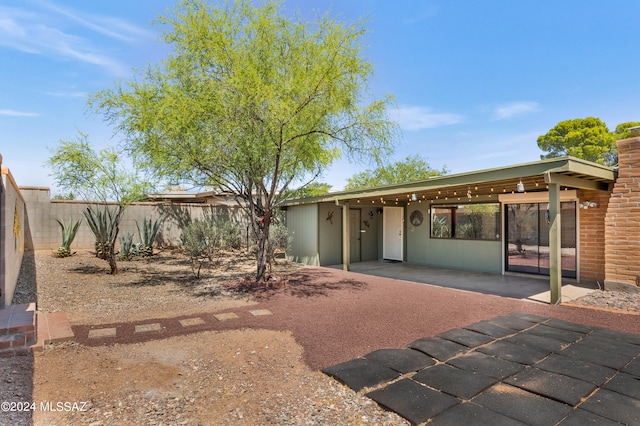 rear view of property featuring a patio area